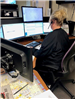 A dispatcher monitors several computer screens