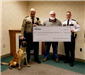 Polk County Sheriff Tadman receives a donation from Otter Tail Power Company.