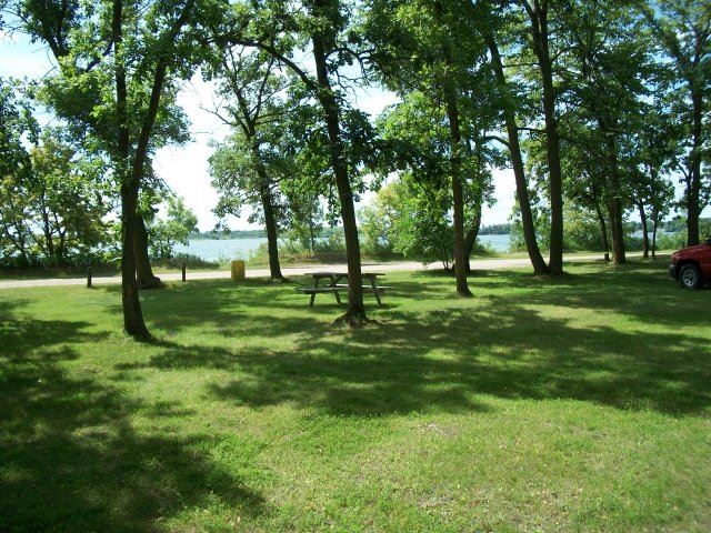 Picnic Table Among the Trees with Water in the Background at Roadside Park