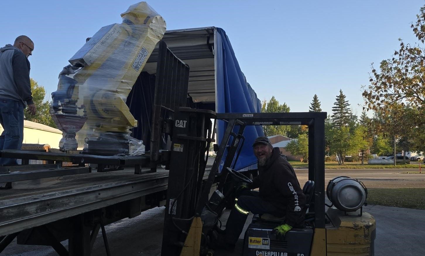 Polk RRF staff unloading Waste Robotics AI Sorter and Fanuc Robotic Arms 